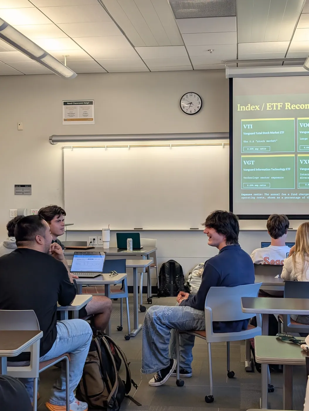Club officers speaking with students in a relaxed classroom setting