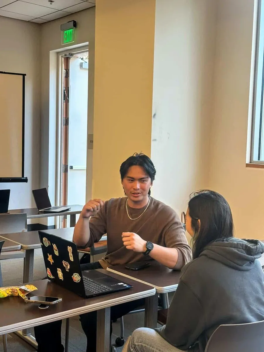 Two students talking during a workshop