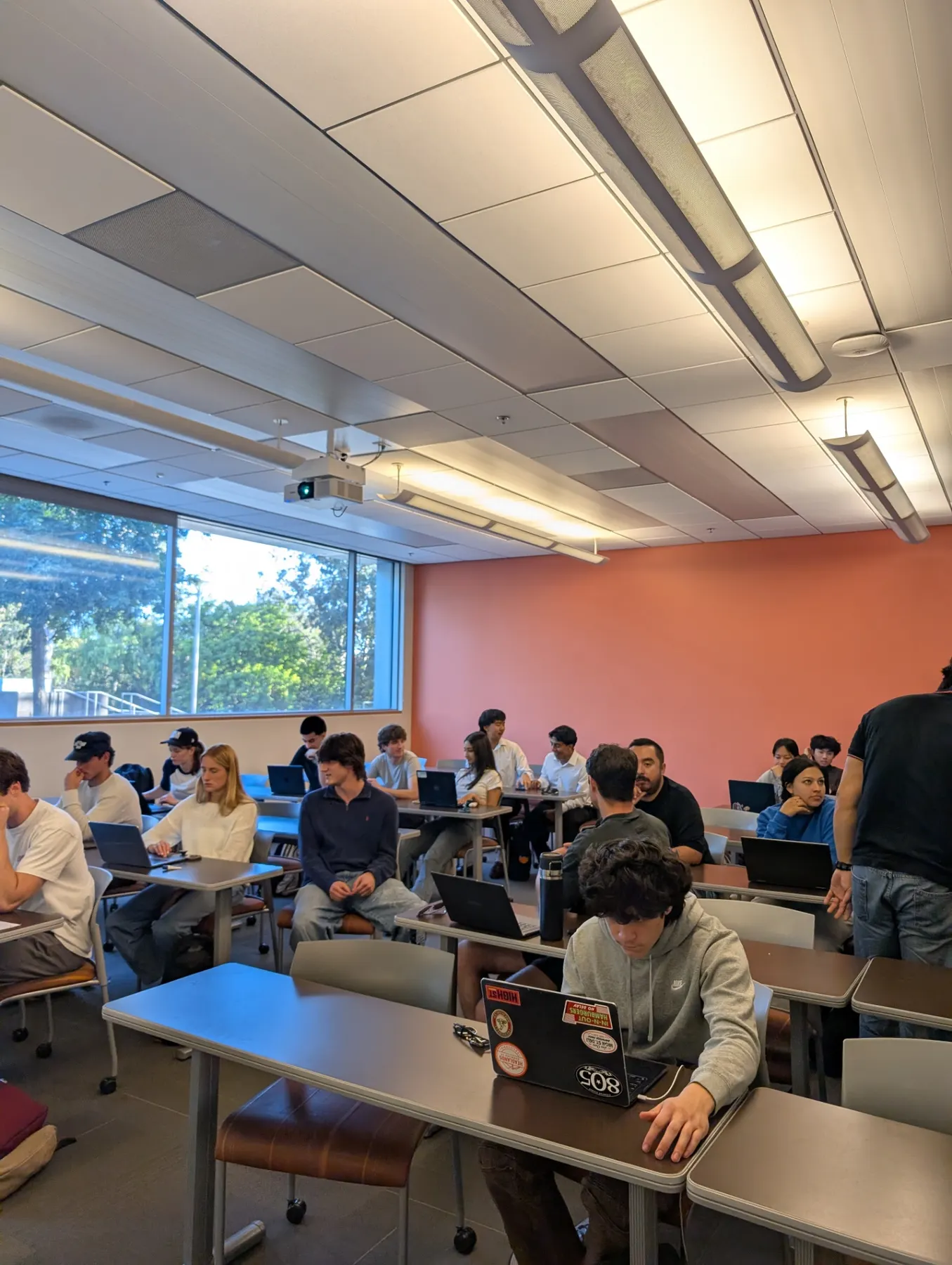 Students spread across a classroom during a hands-on workshop